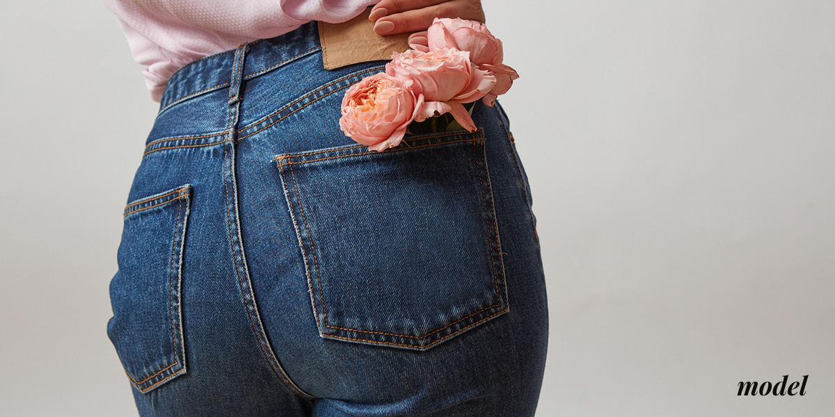 Close Up of Womans Buttocks With Flowers in Back Pocket of Jeans