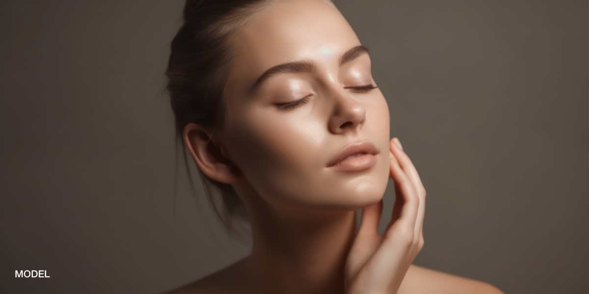 model touching face after a facial